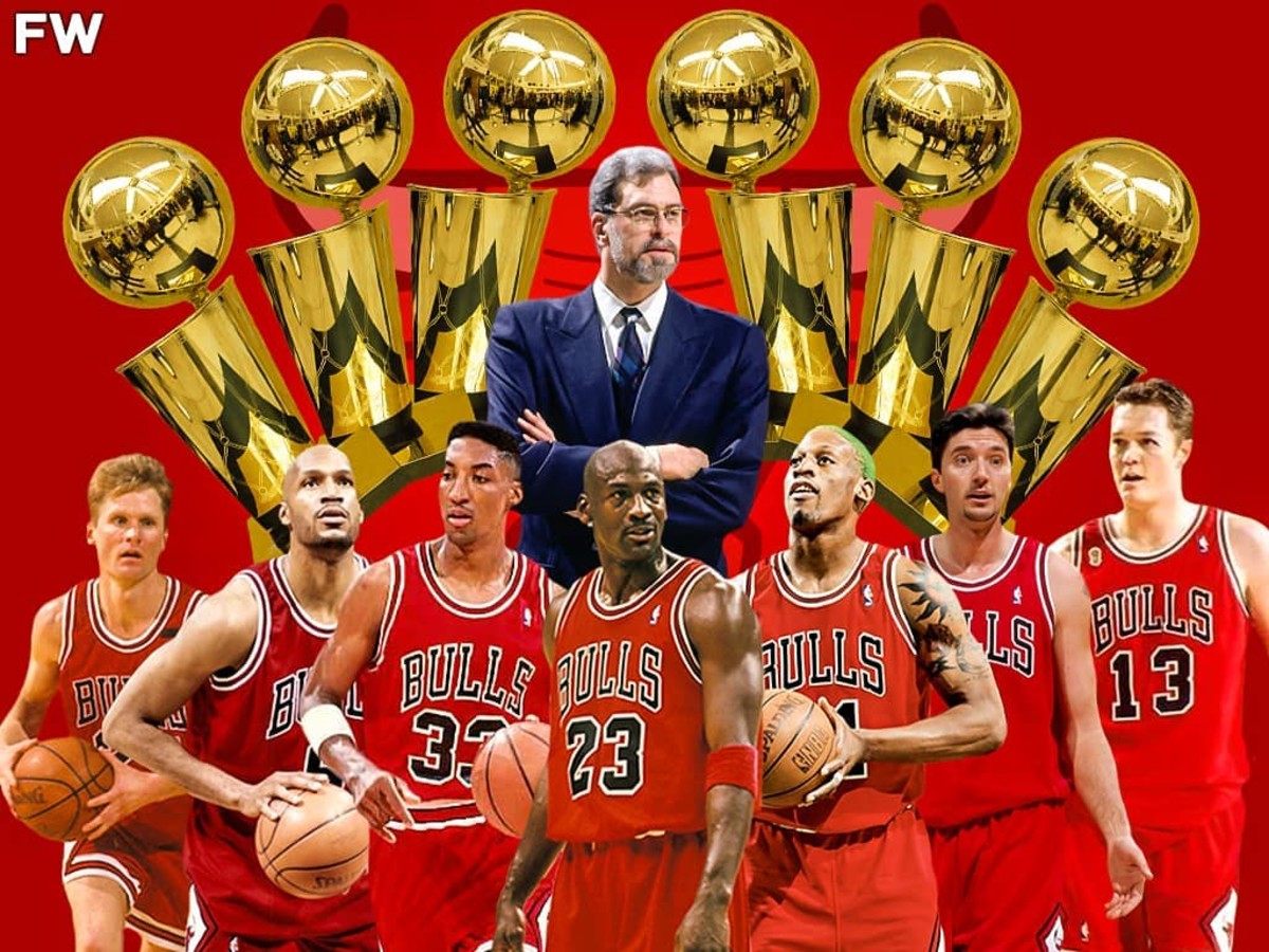 Hình trên là một ảnh minh họa đội hình huyền thoại của Chicago Bulls dưới thời huấn luyện viên Phil Jackson, với sáu chiếc cúp vô địch NBA phía sau. Các cầu thủ nổi bật bao gồm Michael Jordan, Scottie Pippen, Dennis Rodman, và những thành viên khác trong đội hình đã giúp Chicago Bulls thống trị NBA trong thập niên 1990. Ảnh nhấn mạnh thành tích sáu chức vô địch của đội.